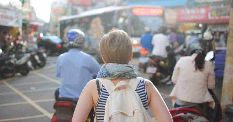 Young girl walking in busy marketplace